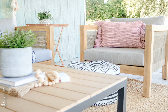 Loving this cozy coastal farmhouse outdoor space! Read through to see how to cozy up your own outdoor living areas! #coastal #coastalstyle #farmhouse #patio #porch #summertime