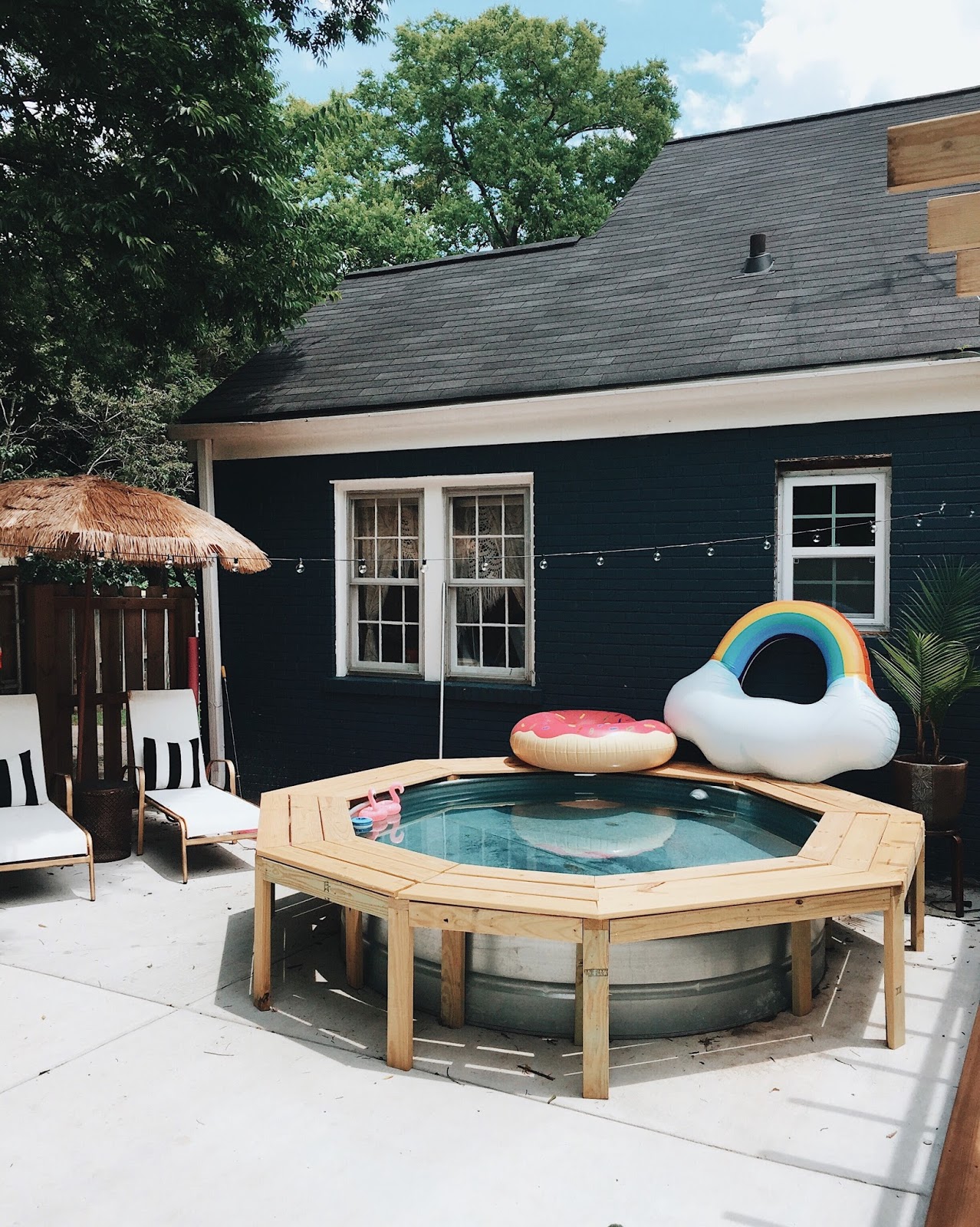 Take a stock tank pool to the next level by adding an easy to build stock tank pool wood bench! Some concerns we've seen about building your own stock tank pool were burns from the pool. This solves the problem and makes getting in and out a breeze! #stocktank #stocktankpool #tankpool #stockpool #stockpooldiy #stockpoolideas