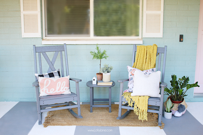 White shutters and companion rocking chairs serve up a generous helping of farmhouse hospitality. The clean spare space on this front porch lends a simple, friendly, and natural elegance to its rural home. #farmhousedecor #rockingchairs #grayrockingchairs #porchdecorations #farmhousedecor