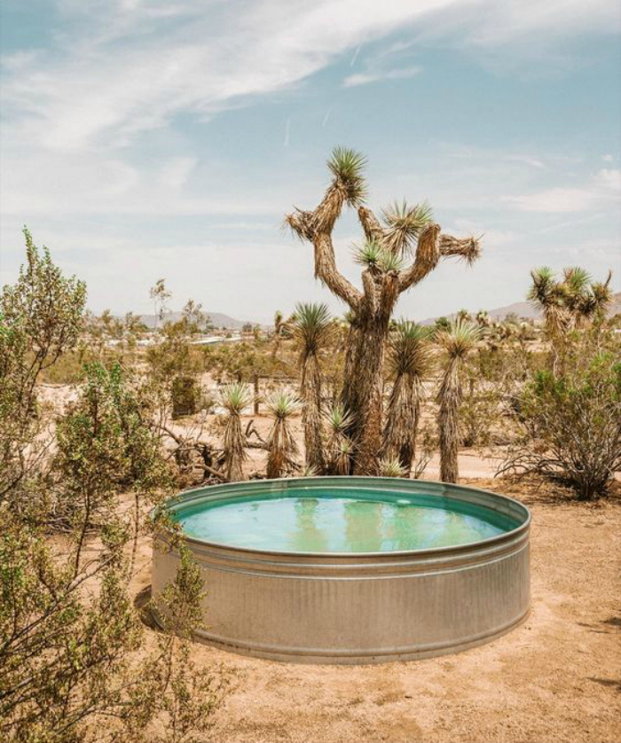 Check out this galvanized tank pool, made from a stock tank! Love this tank pool idea in the desert landscape getaway environment! #stocktankpool #cowboypool #hillbillypool #diypool