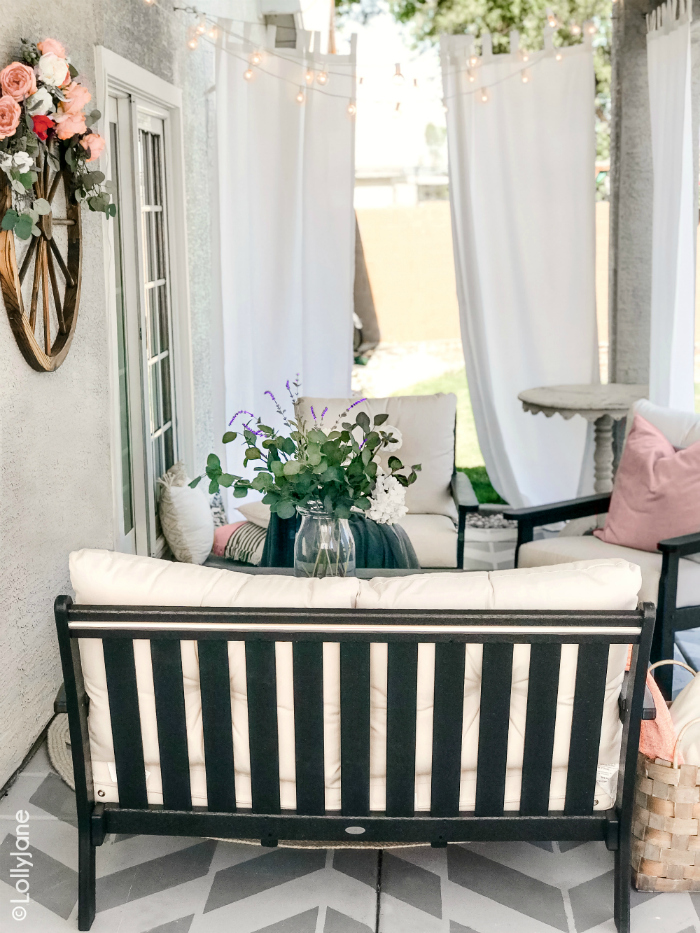 Looking for small farmhouse porch decorating ideas? You'll love this painted concrete porch with its cozy modern farmhouse furniture and round jute rug. #roundrug #farmhouserug #stencilconcrete #farmhousedecor #modernfarmhouse #outdoordecor #porchdecor #polywood