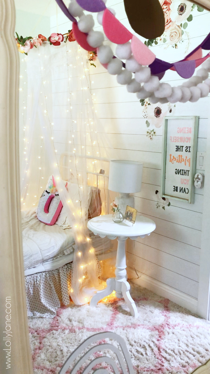 Easy to make floral bed canopy, the cutest accessory for a little girls room! #homedecor #mosquitonet #tulletent #floralcanopy #bedcanopy #diybedcanopy