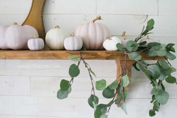 Easy to put together fall mantel with chalk painted pink pumpkins with metallic gold stems paired with natural eucalyptus leaves. #fallmantel #pinkpumpkins #fallmanteldecor #falldecor #falldecorations