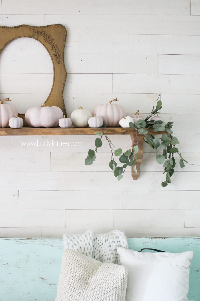 Ahh love these pink painted pumpkins!! Cute easy fall mantel decor, just paint pumpkins and tuck fake eucalyptus leaves in. #diypaintedpumpkins #diypinkpumpkins #pinkpumpkins #colorfulfalldecor #falldecorations #fallmantel #fallfarmhousedecor