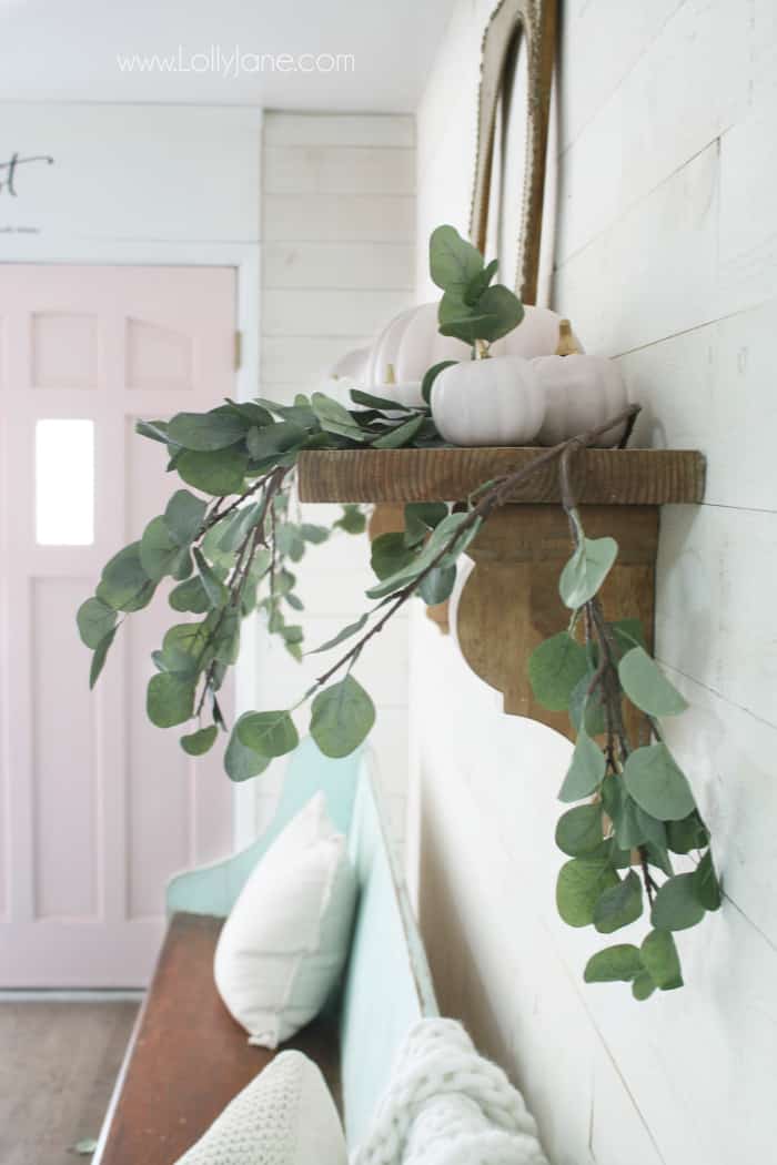 Pretty pink and white fall mantel decor with chalk painted pumpkins and eucalyptus leaves. #falldecor #pinkwhitefalldecor #pinkpumpkins #chalkpaintpumpkins #fallmanteldecor