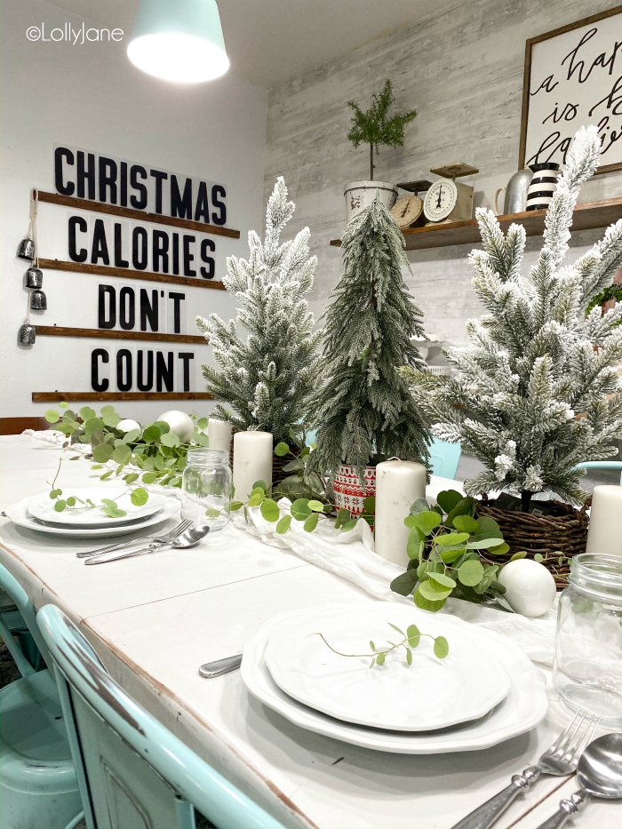 Grab some fresh cut leaves to your table, add white candles and mini trees for easy Christmas table scape idea! #christmasdecor #tablescape #christmascenterpiece