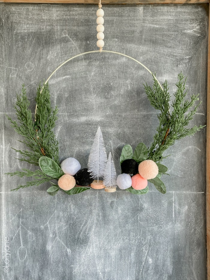 Loving this EASY to make holiday wreath... perfect for winter or Christmas. And SO affordable to copyat! #diy #christmasdecor #christmasdecorations #Christmaswreath #ChristmasDIY