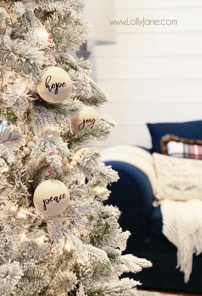 DIY Script Wood Ball Ornament | Add a pretty script sticker to these unfinished wood ornaments to create custom ornaments on the cheap! Such a fun easy to make Christmas craft! #handmadeornament #scriptwoodvballornament #woodballornament #sphereornament #diychristmas