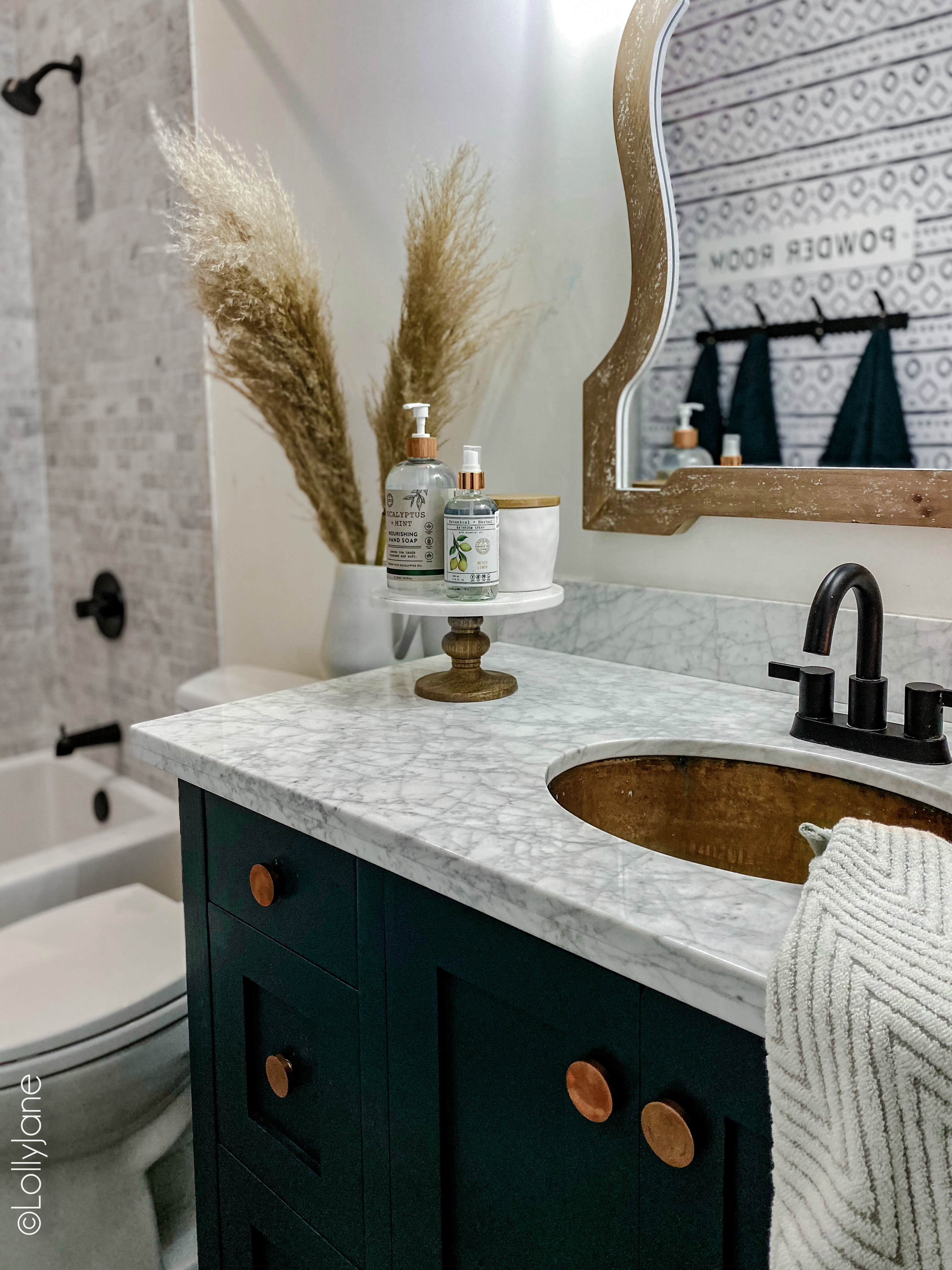 Small Modern Farmhouse Bathroom, so pretty! See how we made every inch of this space practical! #modernfarmhouse #modernfarmhousebathroom #marbletile #subwaytile