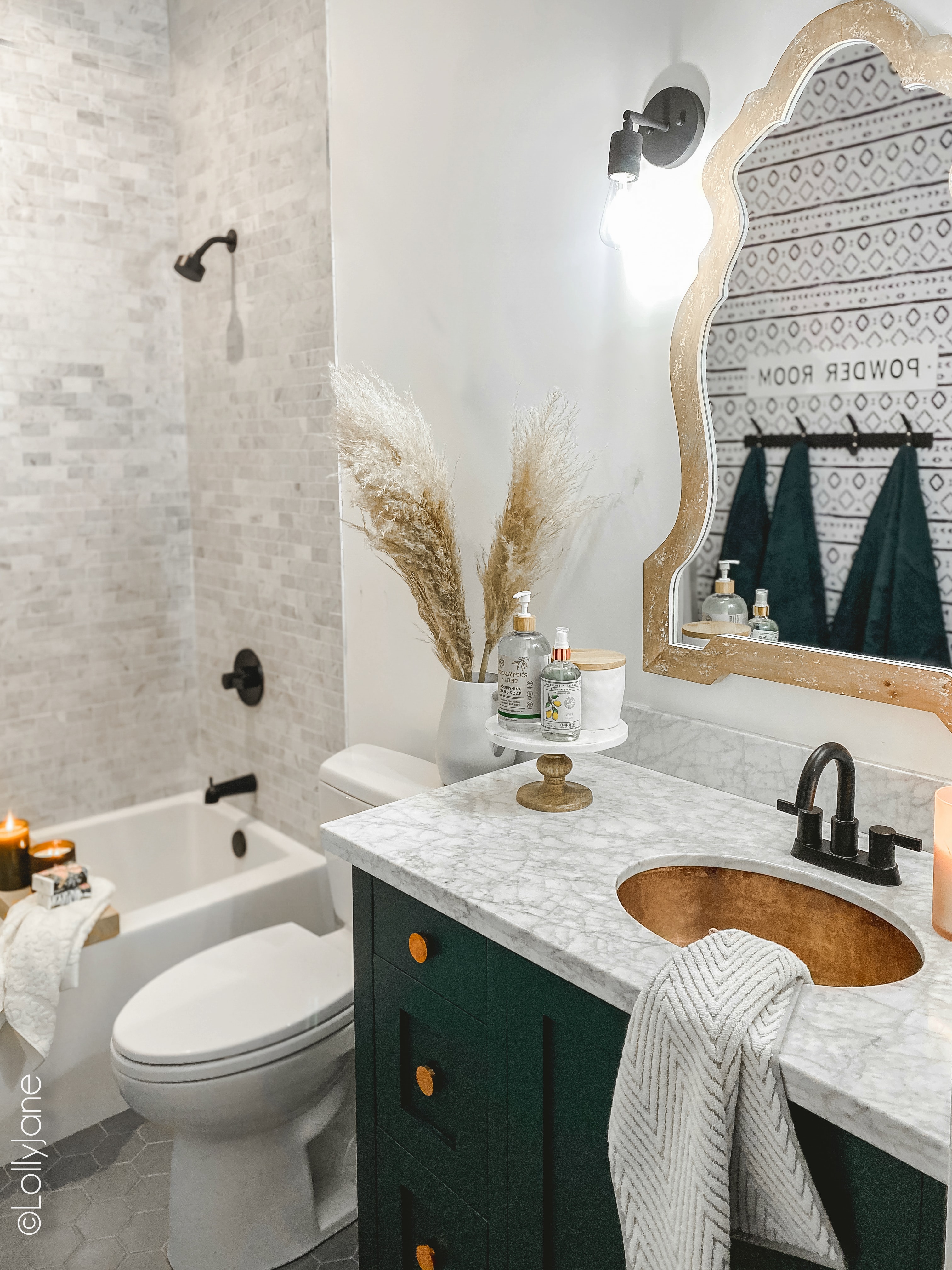 Pretty Modern Farmhouse Bathroom that had a ton of style with great storage solutions! #modernfarmhouse #modernfarmhousebathroom #marbletile #subwaytile
