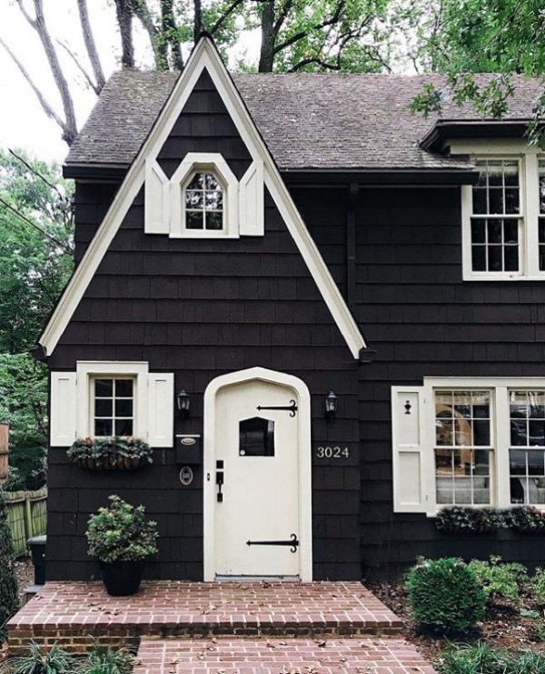 Gorgeous black house with white trim! Adore this exterior paint ideas for a lovely cottage home with dark paint and light trim. Such a pretty contrast! #blackandwhitehouse #darkhouse #darkhousepaint #exteriorpaintcolors #blackpaintedhouse #blackexteriorpaint #blackandwhitehouse