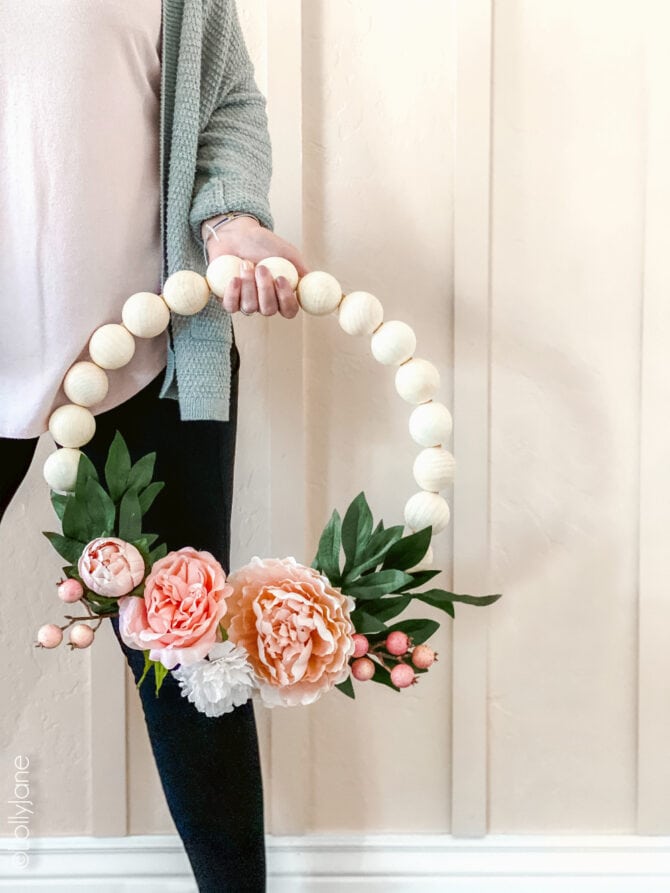 Wood Bead Wreath with Florals that perfect for spring or any time of year! EASY to make for DIYers of any level, click through for the simple how-to! #wreath #wreathdiy #diywreath #springwreath #wreathsofinstagram #diyspringdecor #springdecor #woodbeadwreath