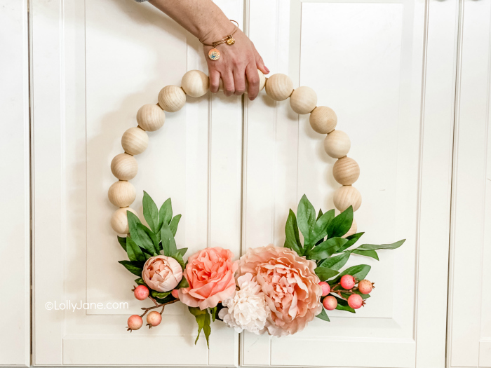 EASY to make for DIYers of any level, click through for the simple how-to! Wood Bead Wreath with Florals that perfect for spring or any time of year! #wreath #wreathdiy #diywreath #springwreath #wreathsofinstagram #diyspringdecor #springdecor #woodbeadwreath