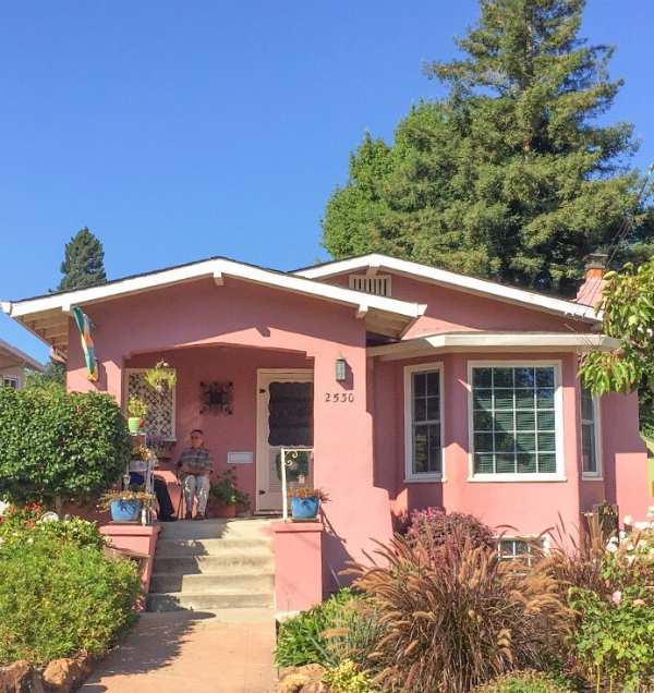 Such a pretty pink exterior painted house, set in CA. Pretty pink coastal home, sure to bring you a smile! #paintedpinkhouse #pinkpaintedhouse #colorfulexterior #darkexteriorpaint #darkpaintcolors