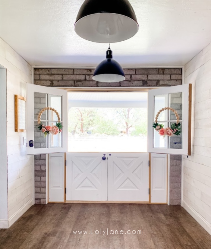 White double dutch doors fit this farmhouse home perfectly! Considering installing dutch doors in your home for natural light and easy access to talk to people without fully opening the door. #dutchdoors #installingdutchdoors #farmhousedoors #farmhousedutchdoors #doubledutchdoors