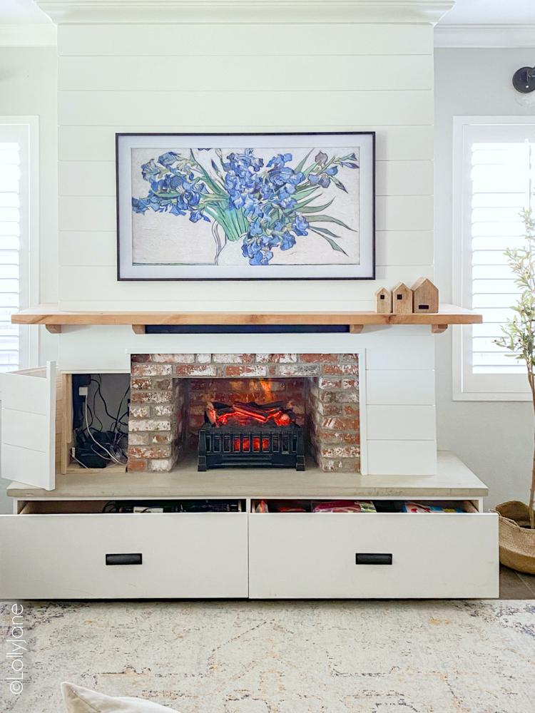 Stunning DIY Entertainment Center with 5 hidden design features that hide clutter and cords but make a BIGG statement! #modernfarmhouse #fauxfireplace #entertainmentsystem #diy #diyhomedecor