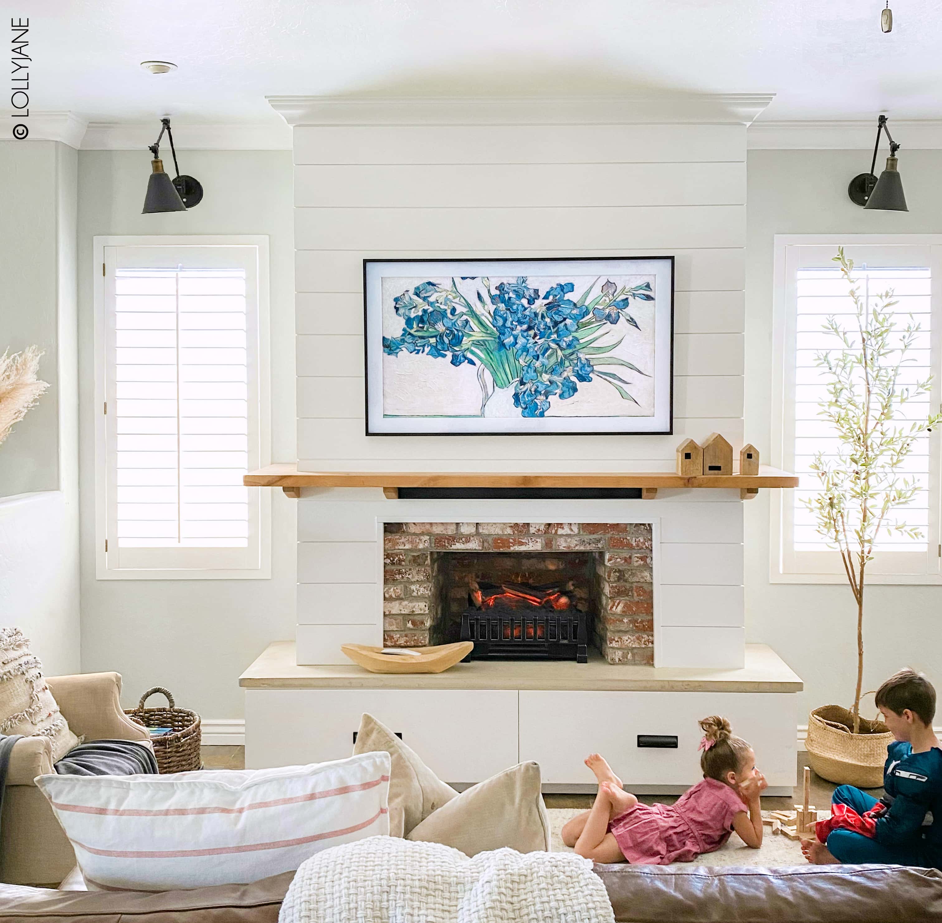 Stunning DIY Entertainment Center with 5 hidden design features that hide clutter and cords but make a BIGG statement! #modernfarmhouse #fauxfireplace #entertainmentsystem #diy #diyhomedecor