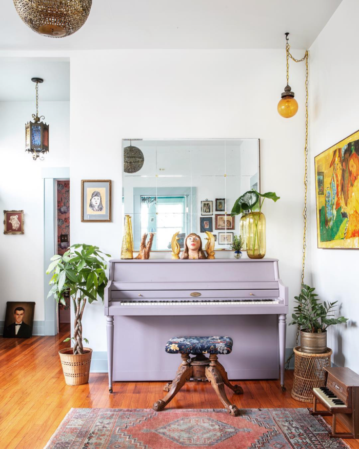 Loving this bold lavendar painted piano. Such a fun statement piece in this eclectic boho style room! #lavendarpaintedpiano #paintedpiano #purplepiano #paintedpurplepiano #diypiano