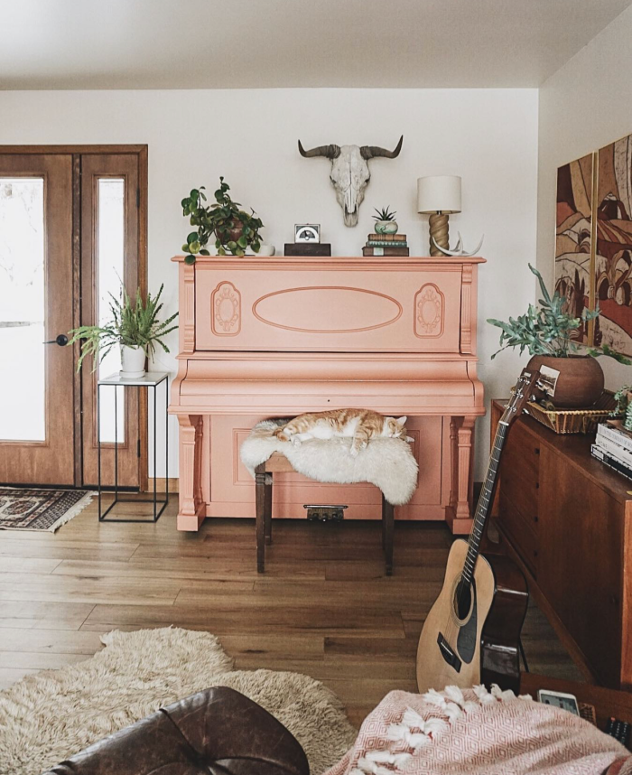 If you're looking for ways to style a boho room around a piano, this is it! Such a fun twist on a pink piano with this terra cotta painted piano! #bohodecor #bohostyle #paintedpiano #pinkpiano #terracottapiano