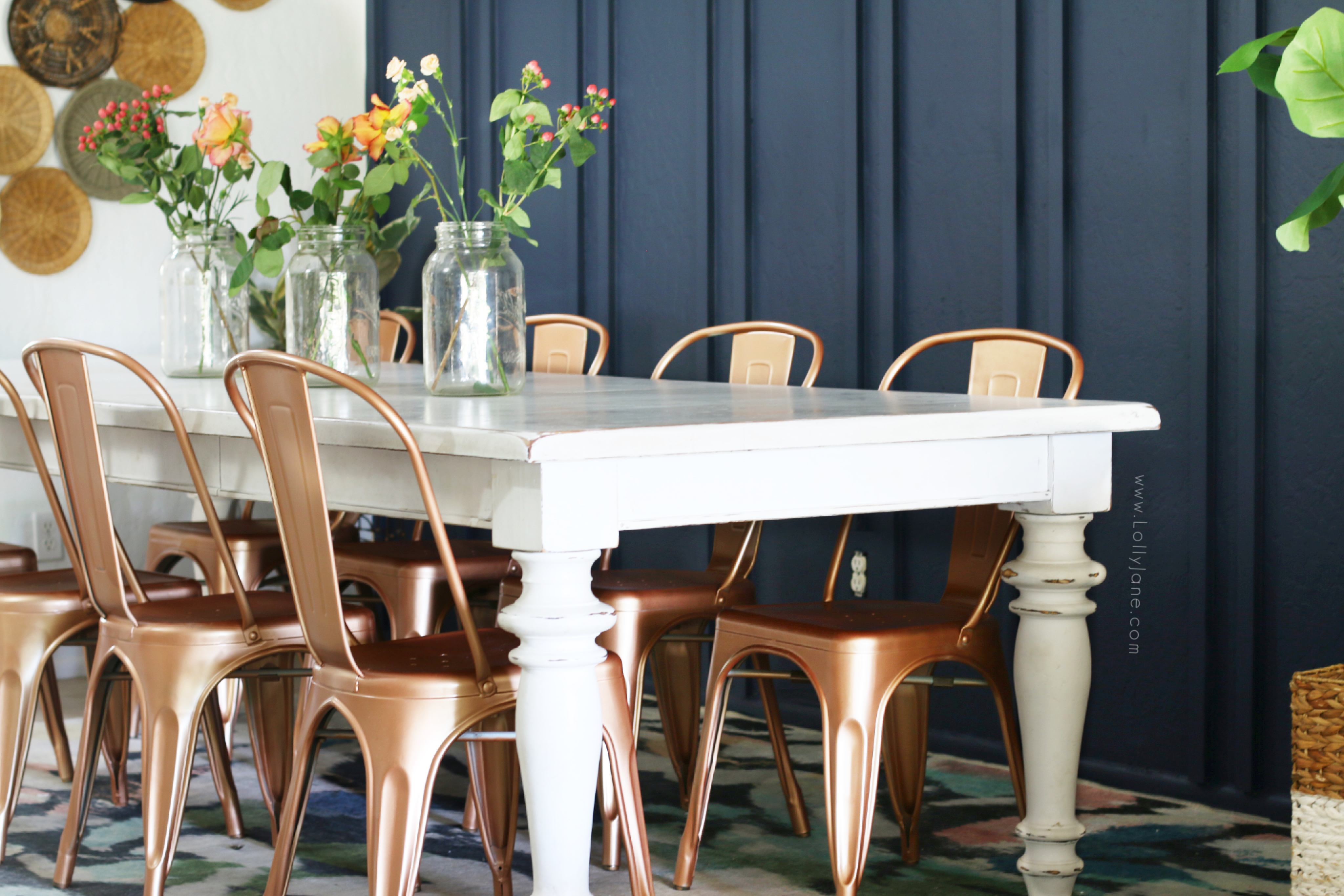 Loving this boho style dining room that fits the modern home while still feeling warm and inviting. Take a look at how we created this beautiful wood double batten wall, thrifted basket wall and how much spray paint changed the whole vibe! #modernfarmhouse #bohostylediningroom #diningroomdecor #howtostyleadiningroom #navybluewoodtreatment #navyboardbattenwall #battenwallideas