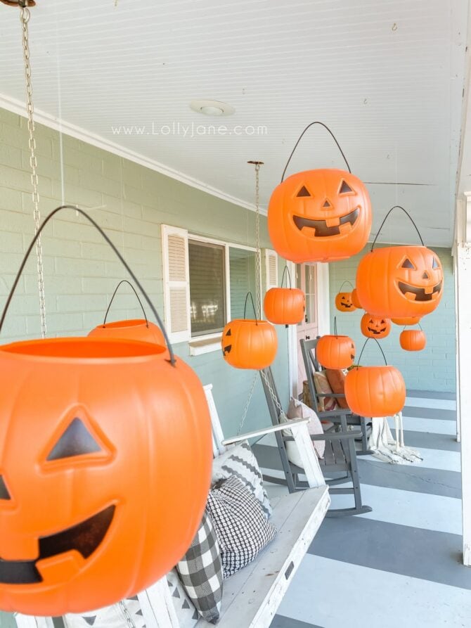 Level up dollar pumpkins for easy Halloween decoration. BONUS: They light up! #dollarpumpkindecor #plasticpumpkinshalloweendecor #hangingpumpkinsporchdecor #hangingpumpkinsoutdoordecor #halloweenoutdoordecor #halloweenporchdecor #halloweenporchpumpkindecor #howtohanghalloweendecor #diyhangingpumpkins