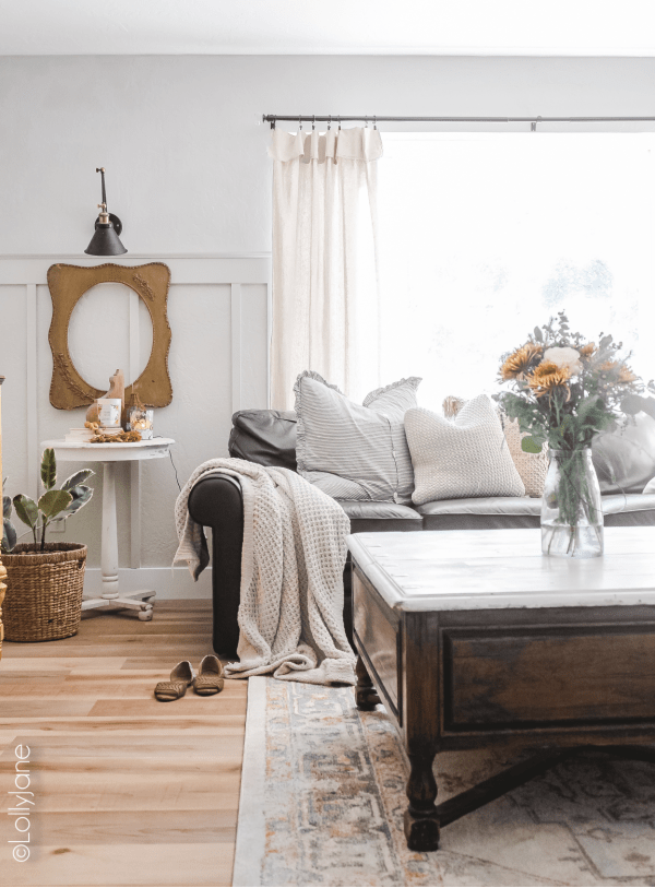 Dying over this gorgeous family room makeover! Less than $1000 to completely transform this room from blah to a stunning modern farmhouse style family room! Such affordable family room decorations without spending a lot of money. #familyroomdecor #familyroomdecorations #familyroommakeover #modernfarmhouse #modernfarmhousefamilyroom #vinylfloors #vinylplankfloors #oakfloors #vinylfloorsfromlowes #procoreplusflooring