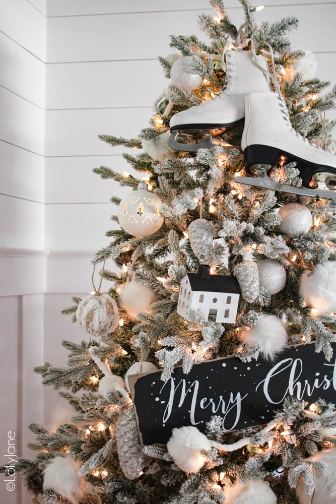Add instant WINTER flair to your own Christmas tree by just adding some extra winter items like ice skates, a scarf, Christmas sign, antlers or anything else you can tuck in between fuzzy pom pom ornaments! #Christmas #christmasdecor #christmasdecorations #iceskates #ChristmasTree #ChristmasTreeTheme #whiteblackchristmastree #christmastreetheme