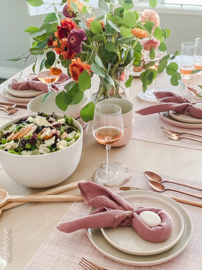 Pretty Easter decor that's perfect on your table top for brunch! Pink plates and rose gold flatware make this Easter table scape pop! #easter #easterdecor #easterdecorations #eastertablecape #springtablescape #tablescape #tabledecor #eastertabledecor