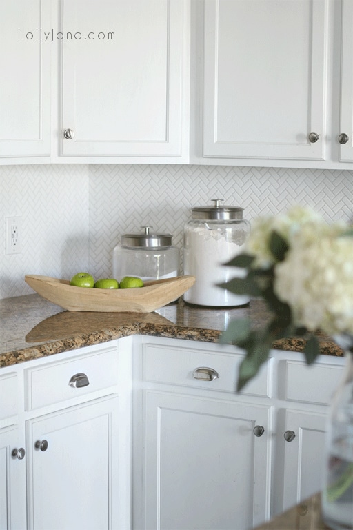 Are you considering small or large herringbone for your kitchen backsplash? We chose the smaller tile to create visual interest. We don't keep a lot of storage on our counters so the herringbone backsplash is the star of the show with the classic look.