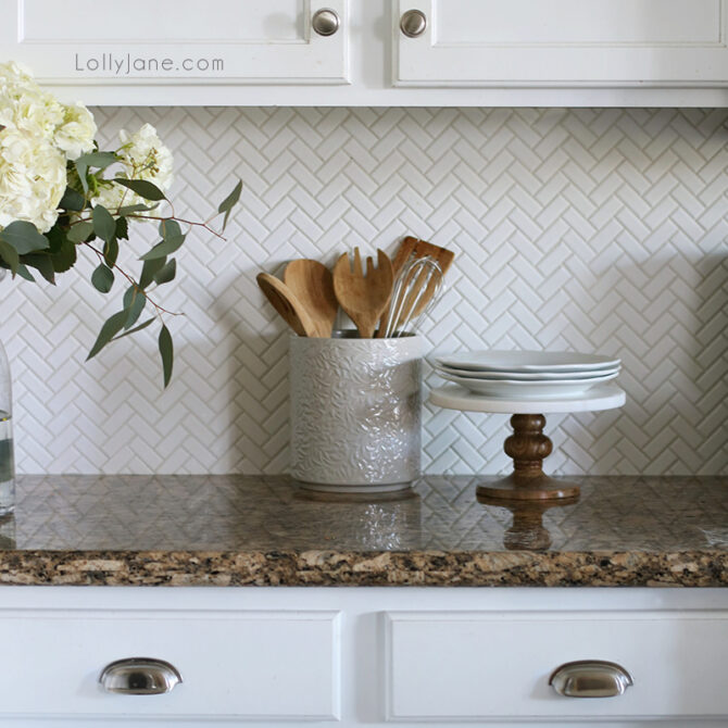 We love our white herringbone backsplash with bright white kitchen cabinets. It's easy to wipe down and creates a timeless, classic look.