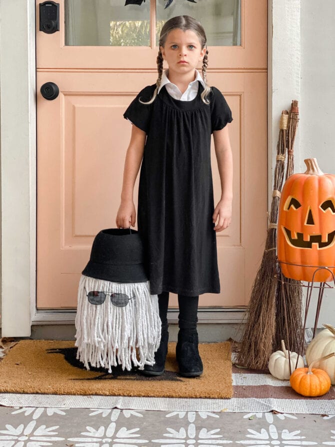 Spooky-Inspired Halloween Costume for Kids: Wednesday Addams Look with  Cousin It Candy Bucket