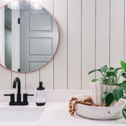 Easy tutorial for a vertical shiplap bathroom wall treatment. Love the cream shiplap in this basement bathroom makeover.