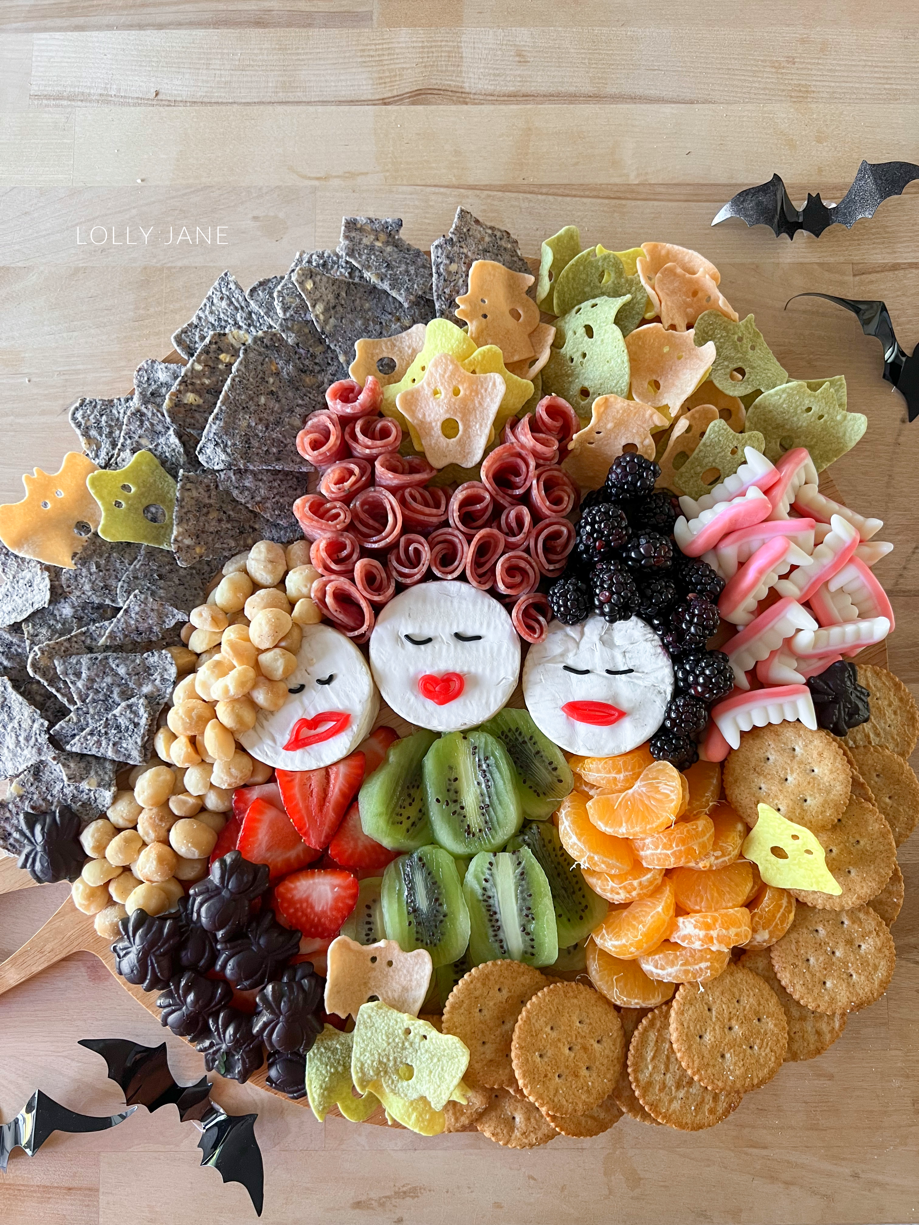 This fun Hocus Pocus themed charcuterie board is the perfect way to kick off the Halloween season! Fill it up with sweet and savory goodies, cute cheese wheel faces, fruits and ghost chips for a not so spooky treat!