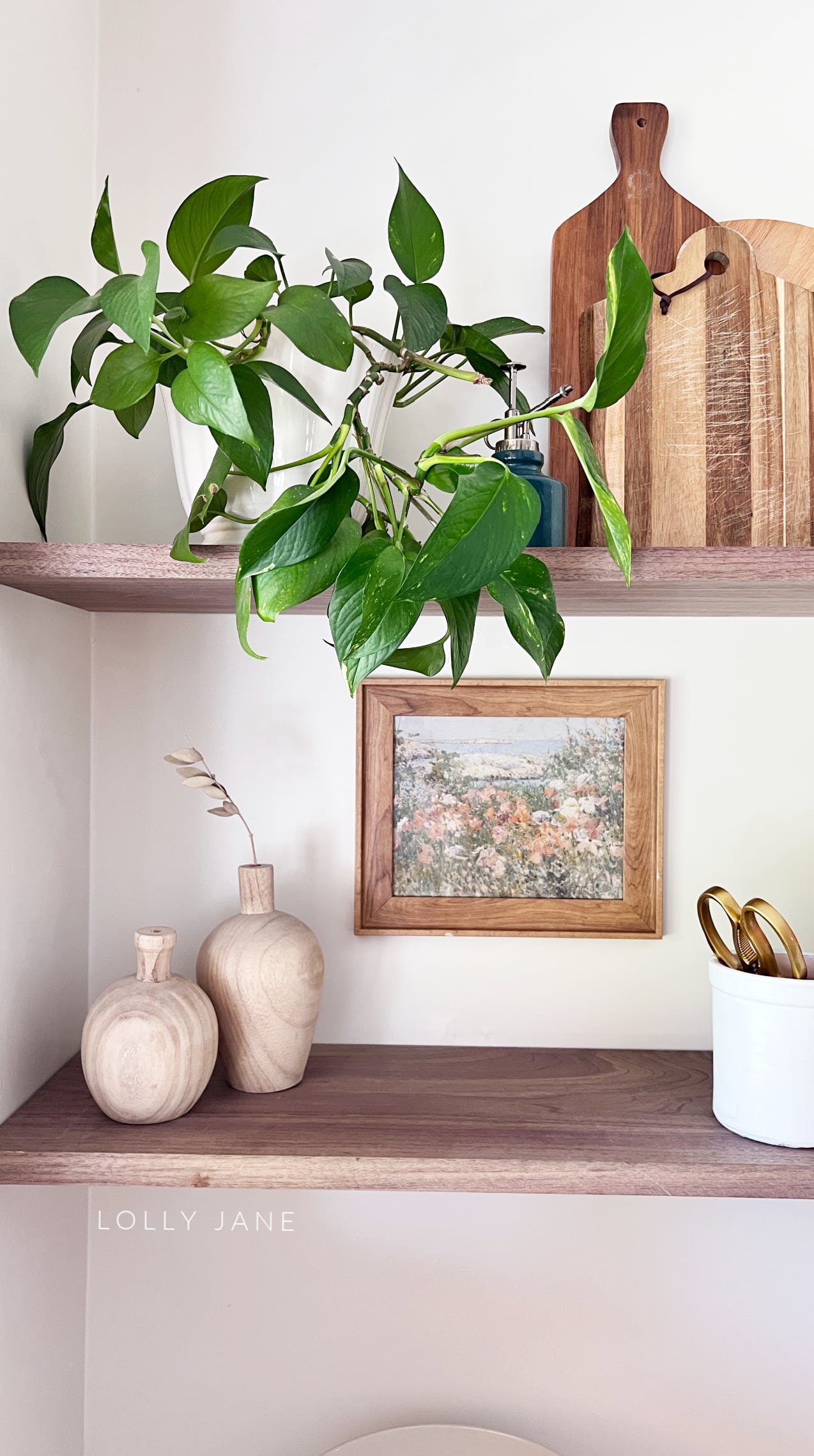 Add a thrifted wood frame with a floral print to open kitchen shelves for easy decor! Up your home decor with thrifted frames and digital art to create custom art for your home.