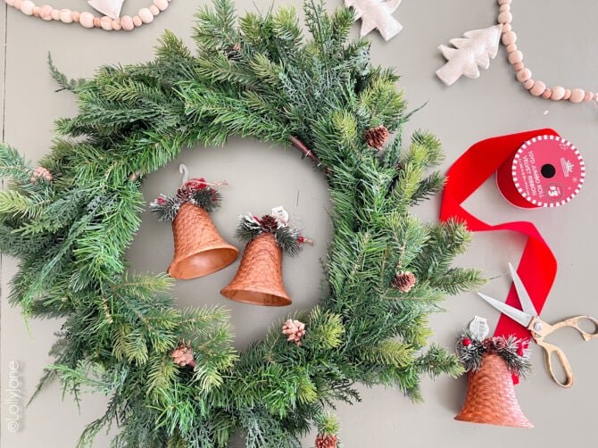 Supplies to make a Christmas wreath that won't break the bank. Our secret: Swap $2 rattan ornaments for brass bells!