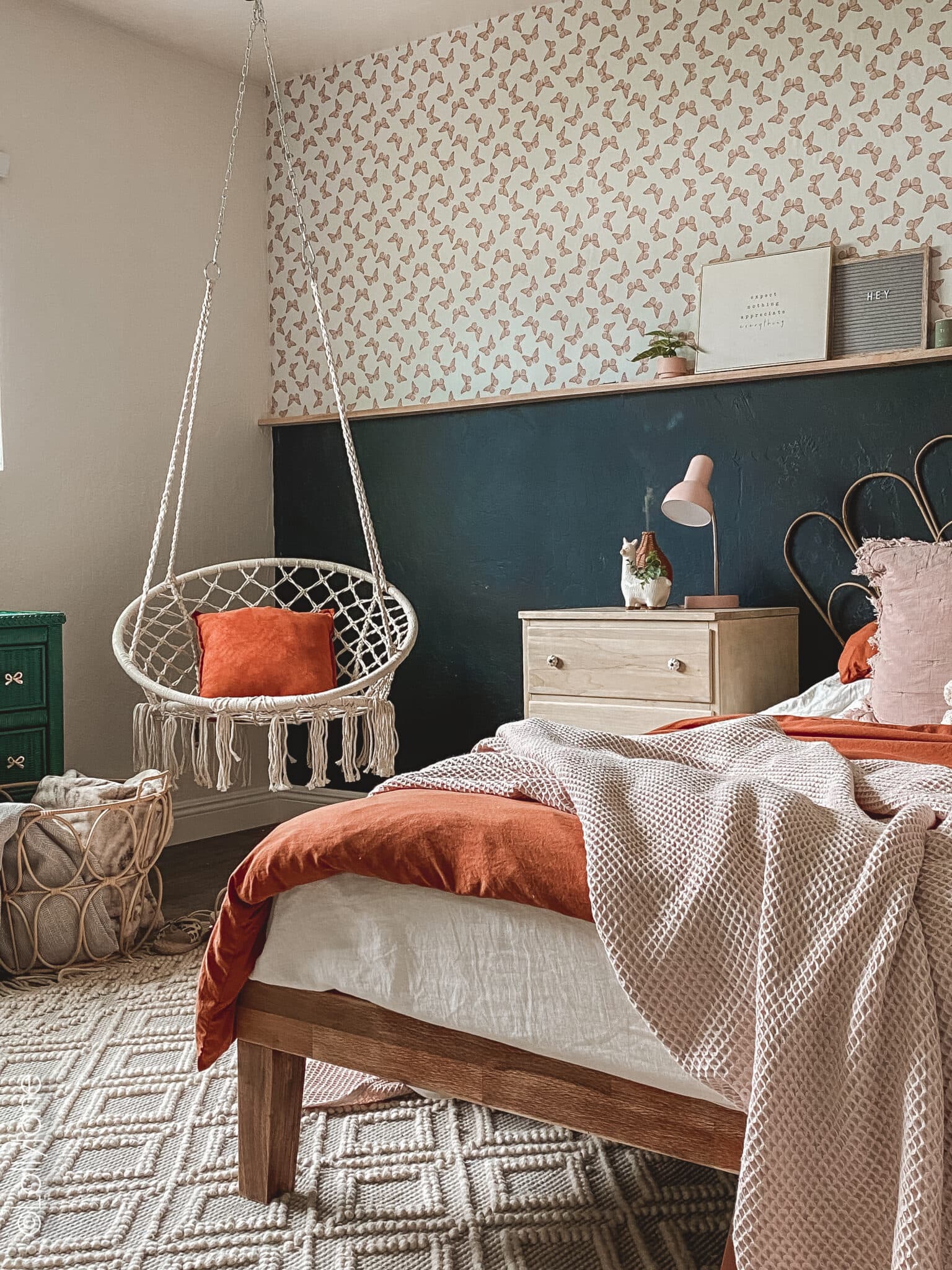 Transform her space into a boho haven with thrifted finds and DIY charm! Mix neutral bedding with boho butterfly wallpaper for a whimsical touch. Add personalized flair with eclectic throw pillows and a DIY shelf, creating a cozy sanctuary with a playful twist. #BohoDecor #GirlsBedroom #DIYInspiration