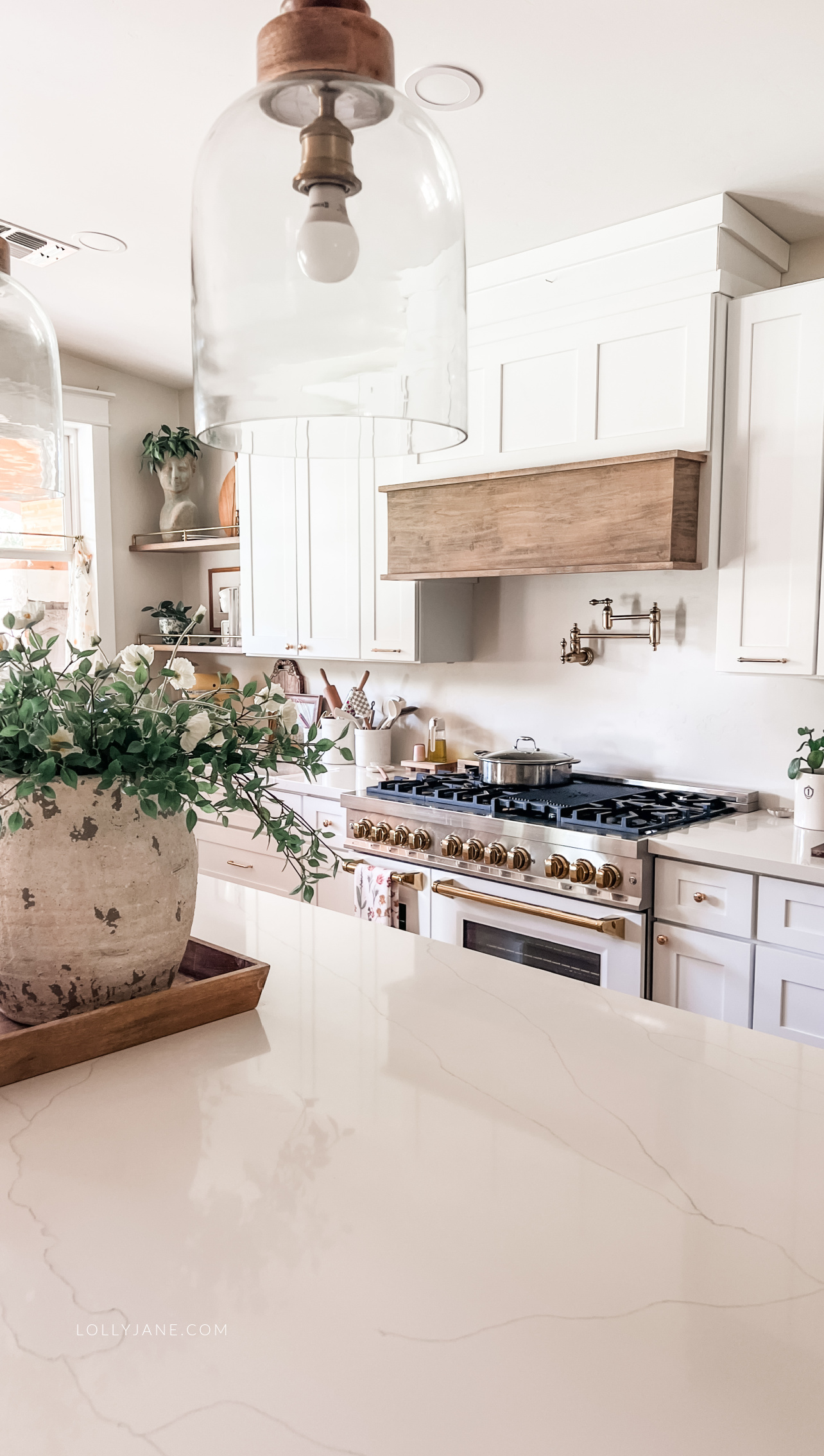 Make your kitchen both stylish and cozy with white cabinets, gold hardware, and charming decor touches that reflect your taste.