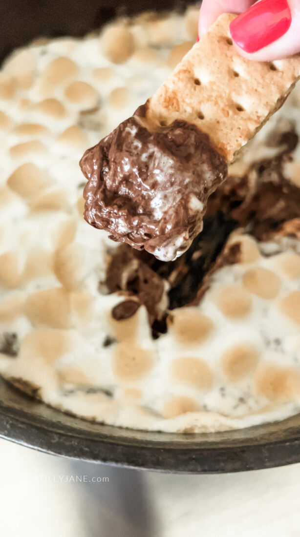 This s'mores dip, made in a cast iron skillet, features melted milk chocolate and marshmallows, oven-baked to toasted perfection. Serve with graham crackers for dipping.