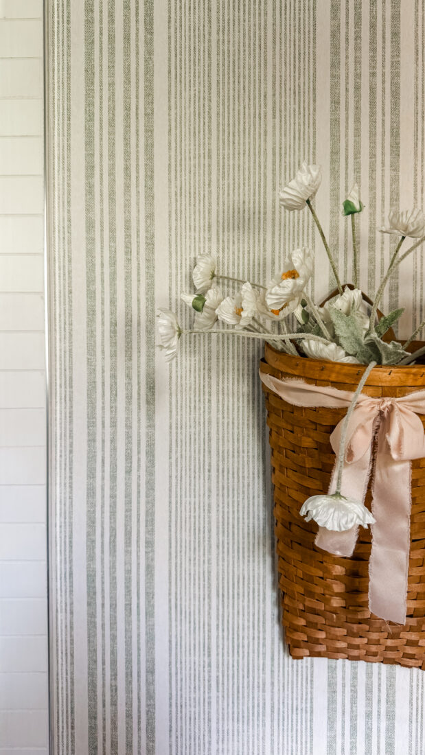 Guest bathroom wall decor with hook, vase vessel, and tea towel.