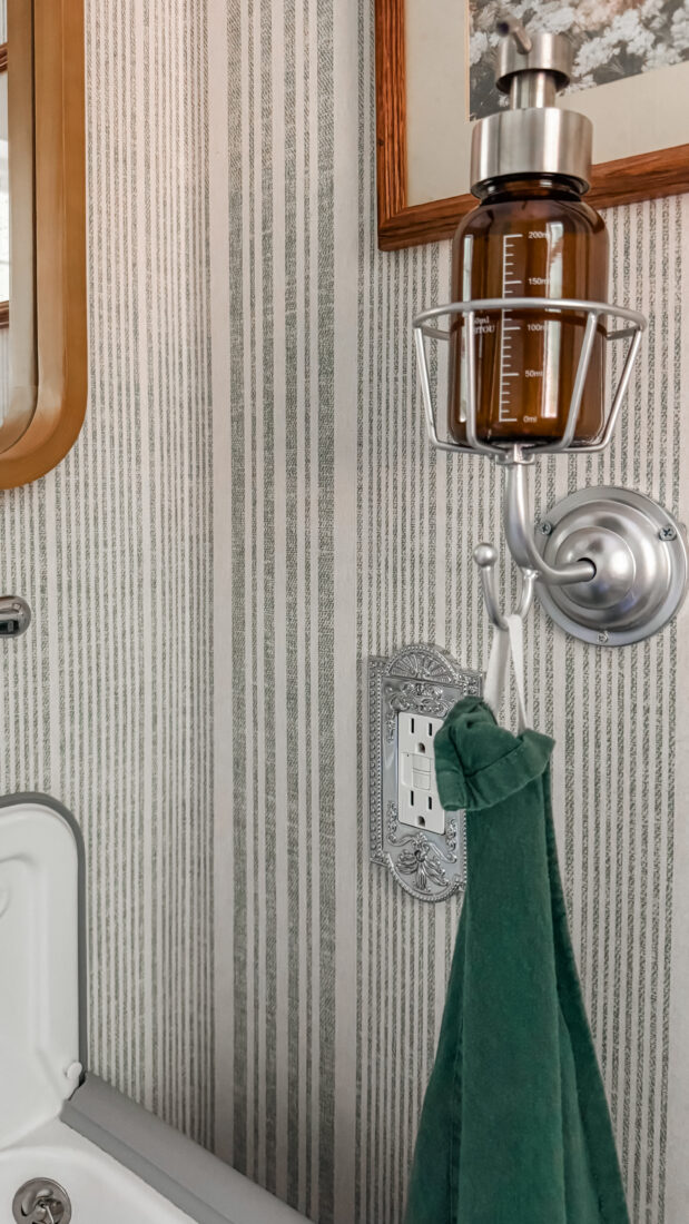 Guest bath redo with green painted door and floral wall basket.