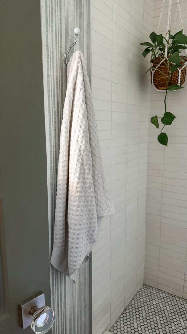 Small bath makeover with decorative chrome wall plates.
