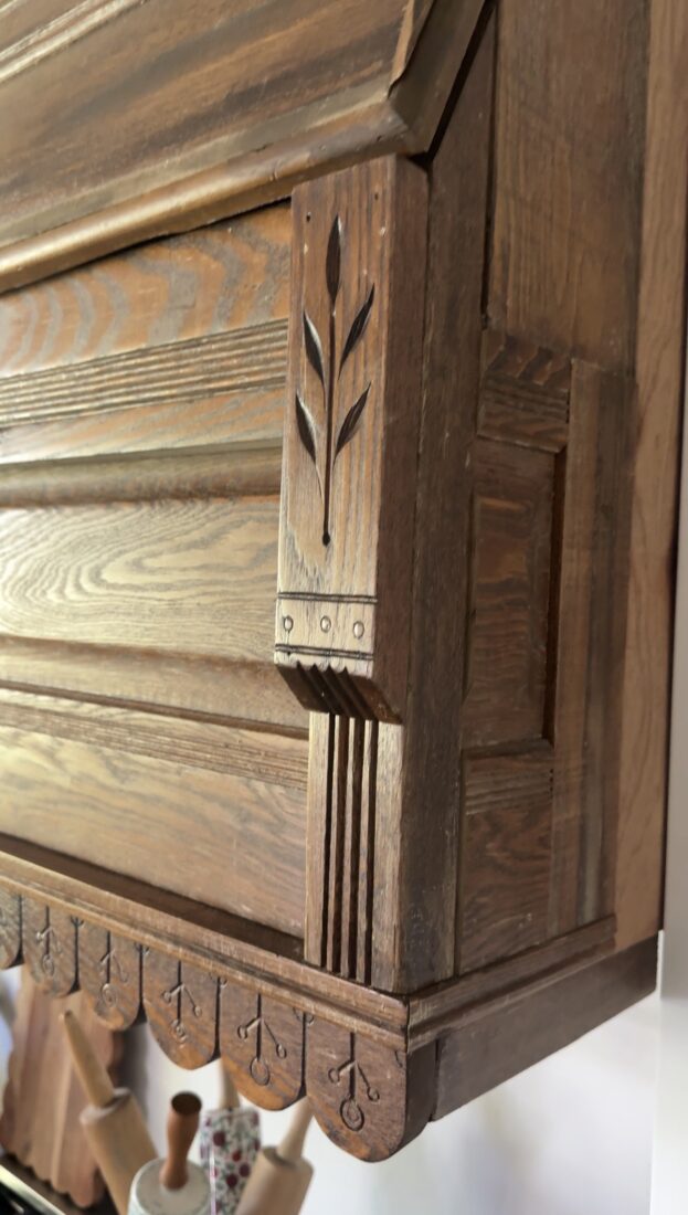 Finished antique headboard kitchen hood in bright white kitchen