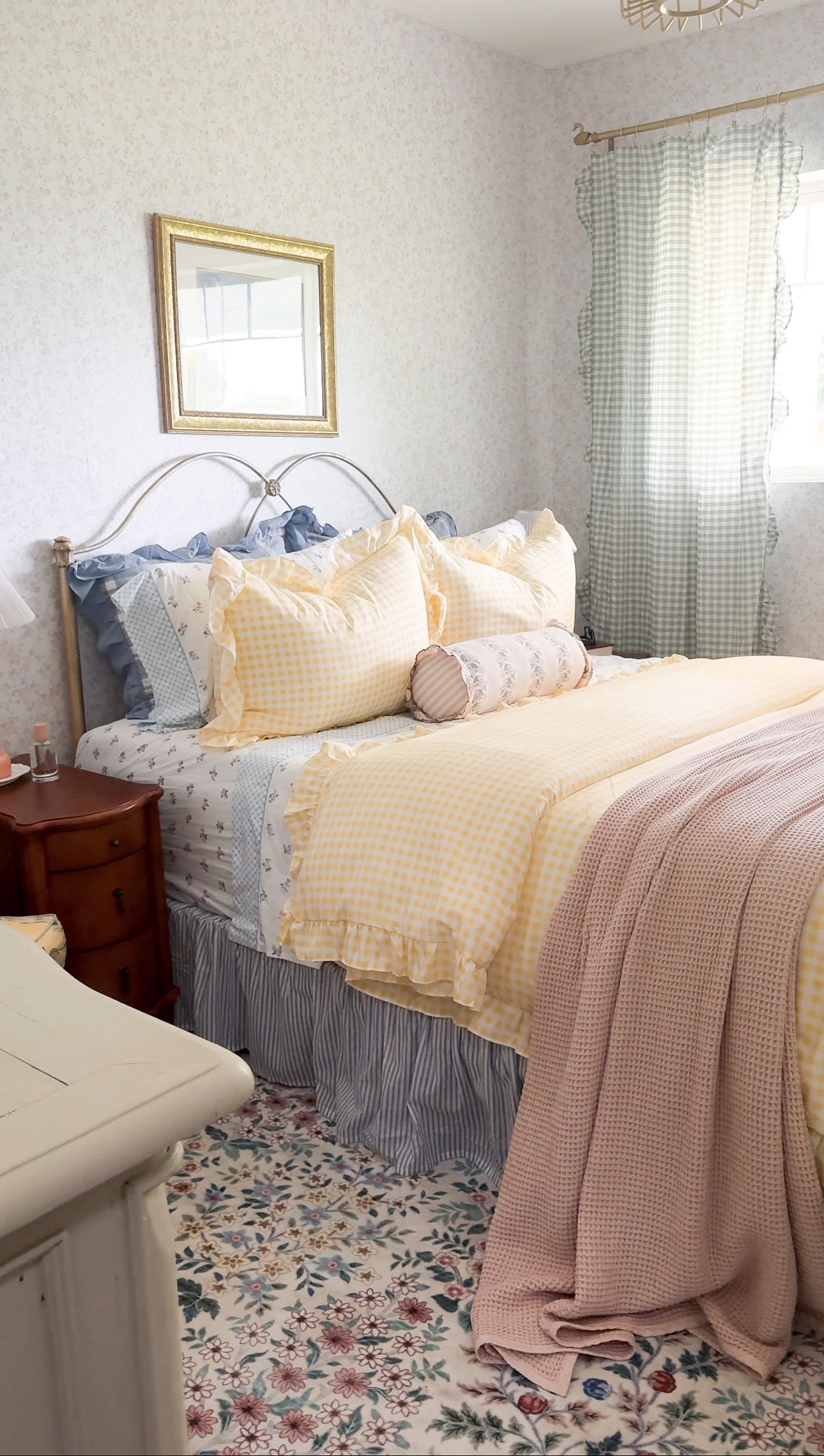Cozy cottage inspired guest bedroom with floral bedding, thrifted decor, soft curtains, and vintage-inspired accents